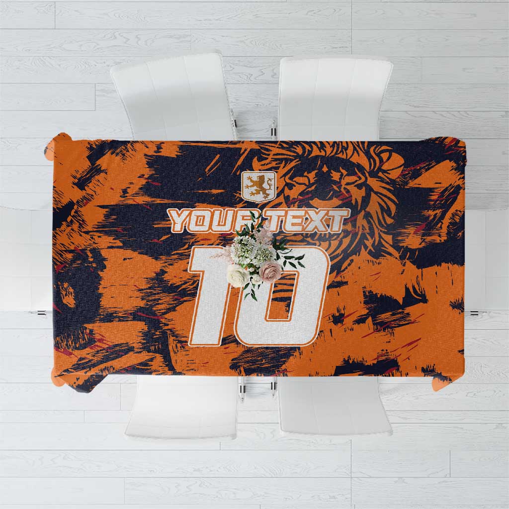 Orange and navy brush-pattern tablecloth with large numeric graphic and crest