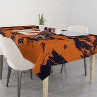 Orange and navy brush-pattern tablecloth with navy accents on table setting