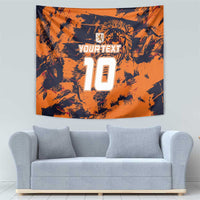 Orange wall tapestry with lion crest, YOURTEXT, and big jersey number 10 above sofa