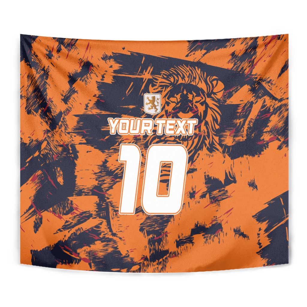 Close-up orange tapestry with dark splatter pattern, lion crest, YOURTEXT, and number 10