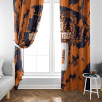 Orange and navy window curtains with jersey-number artwork, hanging on a white-framed window.