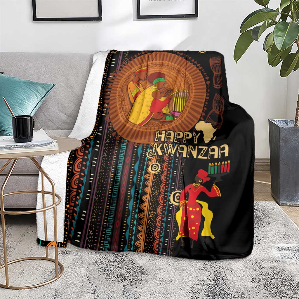 Black blanket with colorful “Happy Kwanzaa” design, portrait circle, and kinara candles