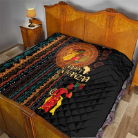 Black quilt on bed with African tribal pattern band, Happy Kwanzaa text and figures