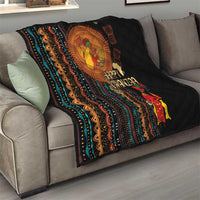 Black throw quilt on sofa with African tribal striping, Happy Kwanzaa text and figures