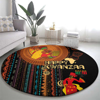 Round area rug showing Happy Kwanzaa text, black base with colorful African tribal artwork.
