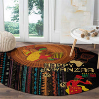 Round area rug with Happy Kwanzaa text and seated figure, black base with bold tribal motifs.