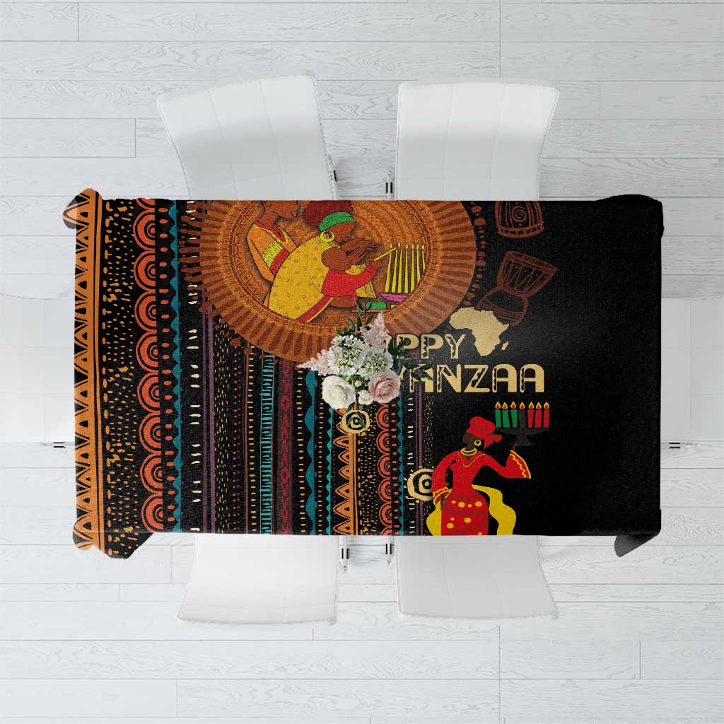 Black tablecloth with tribal pattern and “Happy Kwanzaa” text