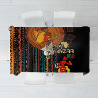 Black tablecloth with tribal pattern and “Happy Kwanzaa” text