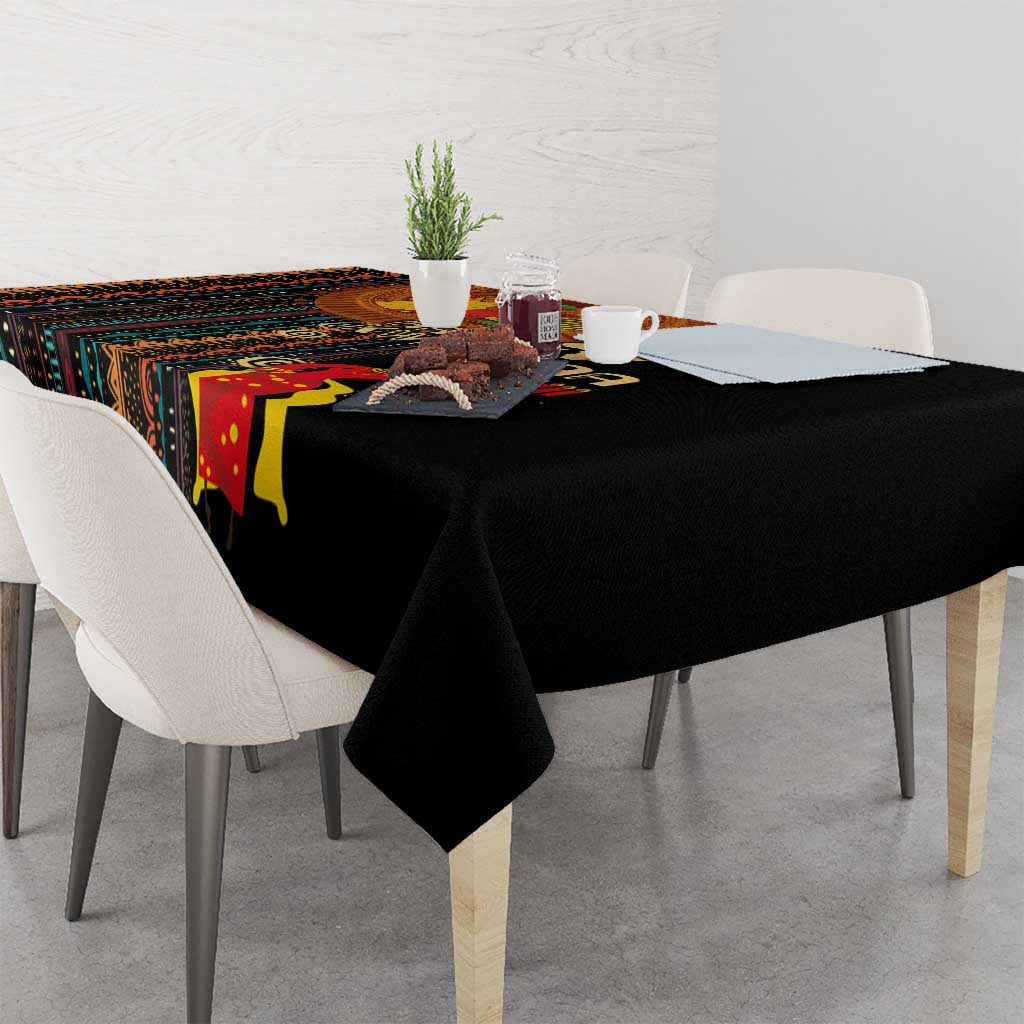 Black tribal-pattern tablecloth draped over a dining table