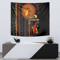 Black African tribal tapestry above console with 'Happy Kwanzaa' and two decorative figures