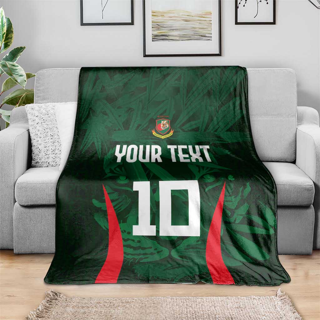 Green cricket blanket on grey sofa with crest, 'YOUR TEXT' and red-striped number 10