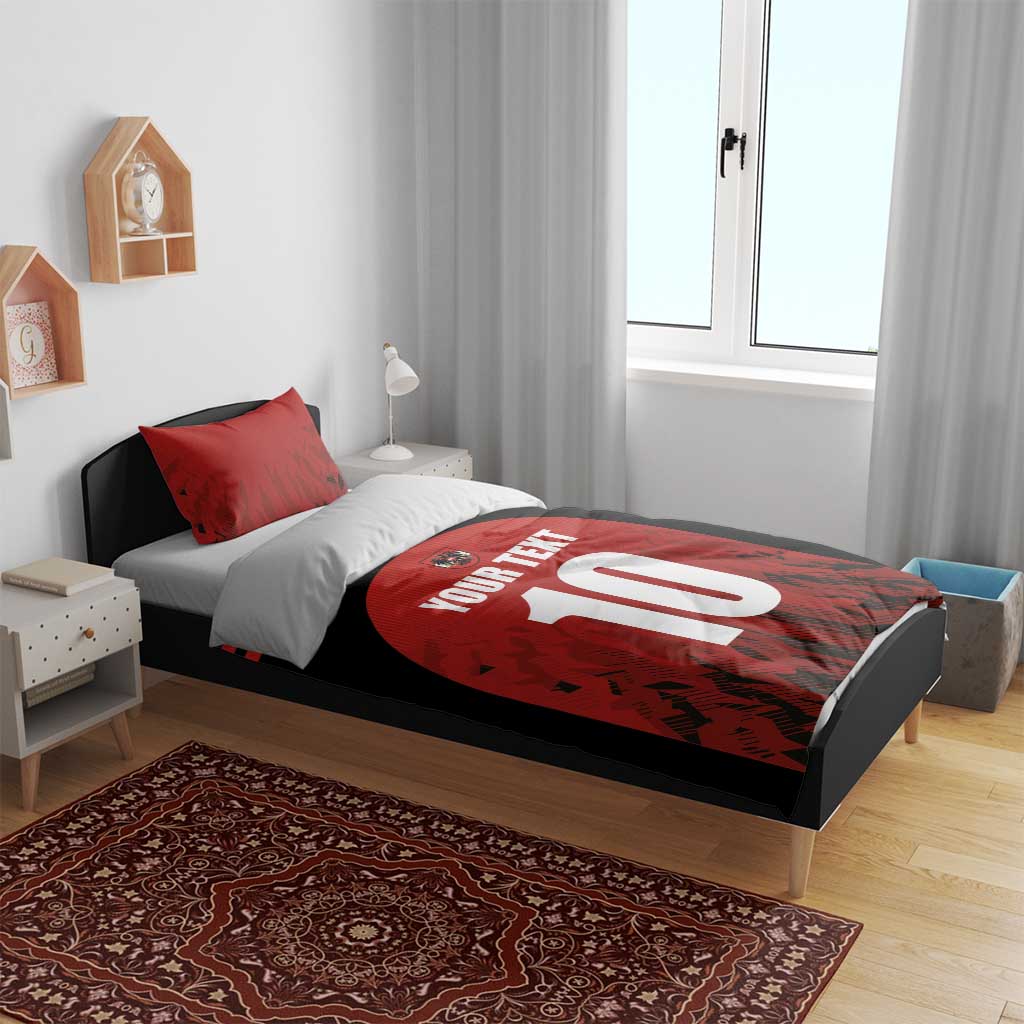 Red and black bedding set with circular 10 graphic and 'YOUR TEXT' text on the duvet