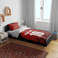 Red and black bedding set with circular 10 graphic and 'YOUR TEXT' text on the duvet