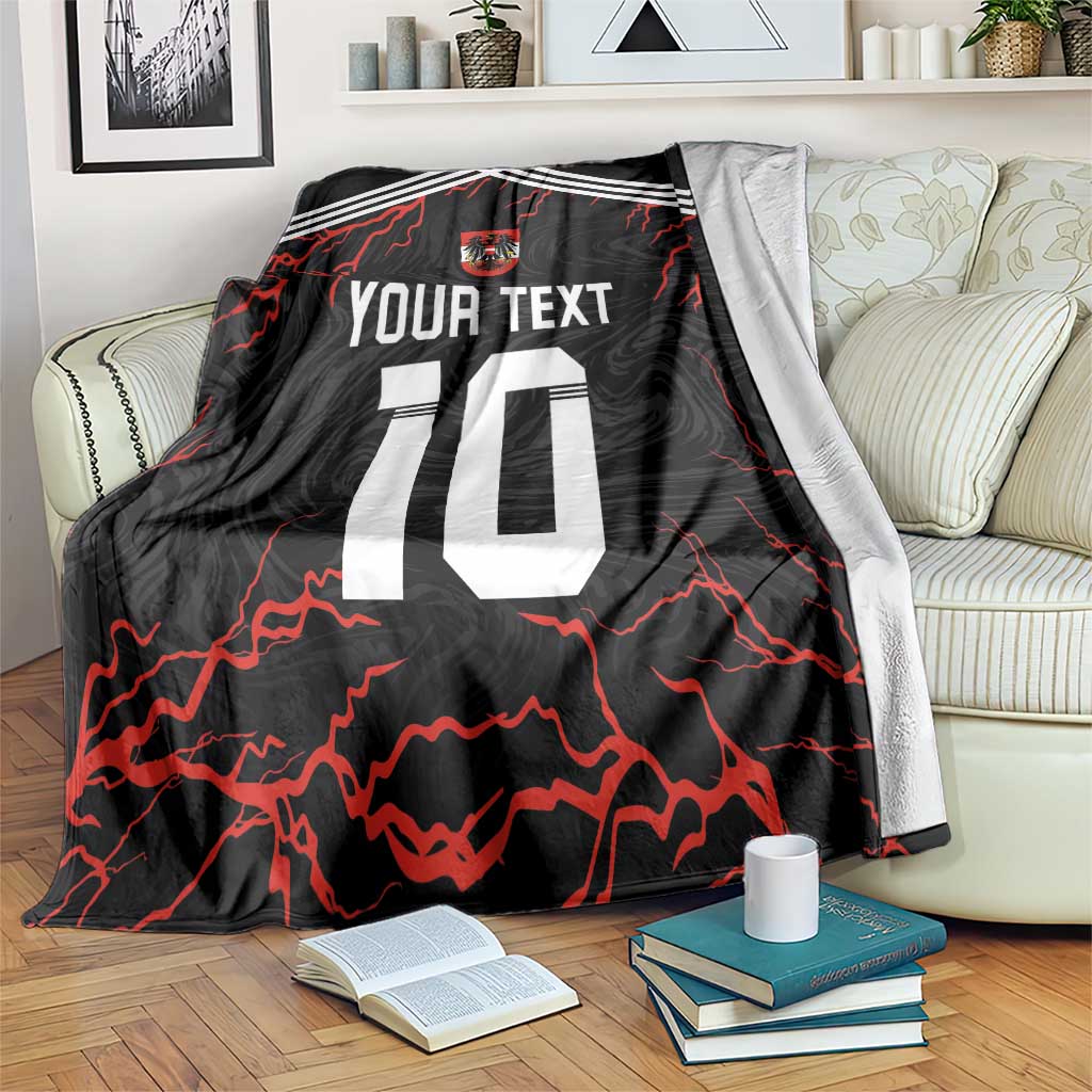 Black football blanket draped over a sofa, red lightning graphics, crest, and number 10