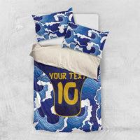 Blue bedding set with wave pattern, yellow custom text, and matching pillow covers