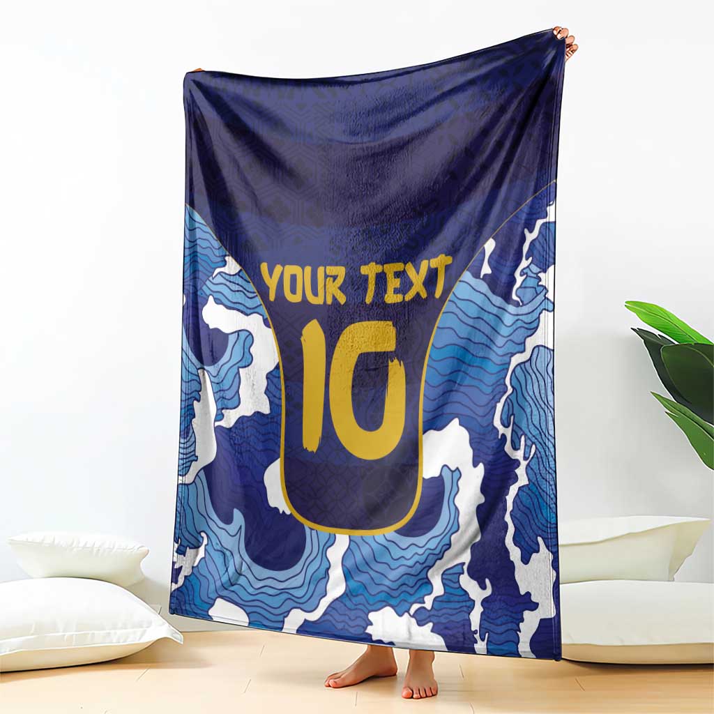 Blue wave-pattern rugby blanket with yellow YOUR TEXT emblem, draped with border