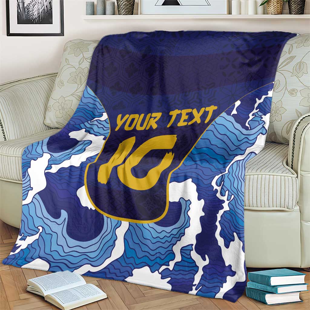 Blue wave-pattern rugby blanket with yellow YOUR TEXT and U-style emblem, folded