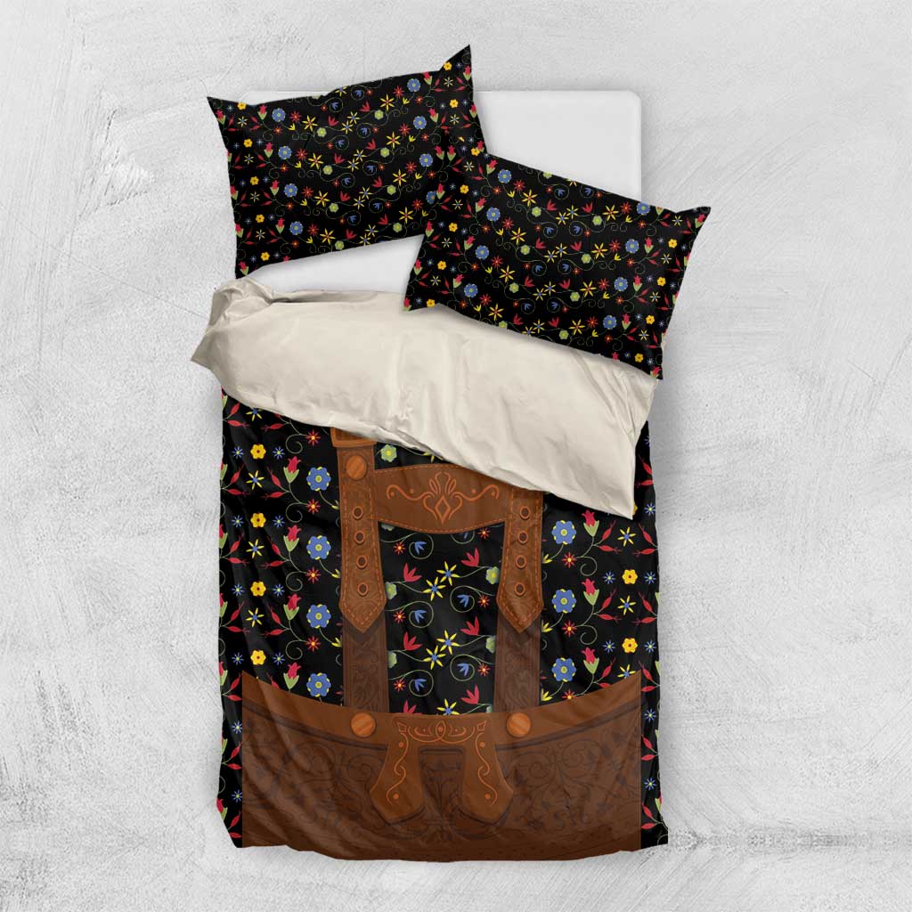 Black bedding set with colorful folk floral design and brown lederhosen-style apron on duvet