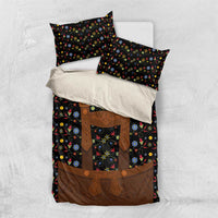Black bedding set with colorful folk floral design and brown lederhosen-style apron on duvet