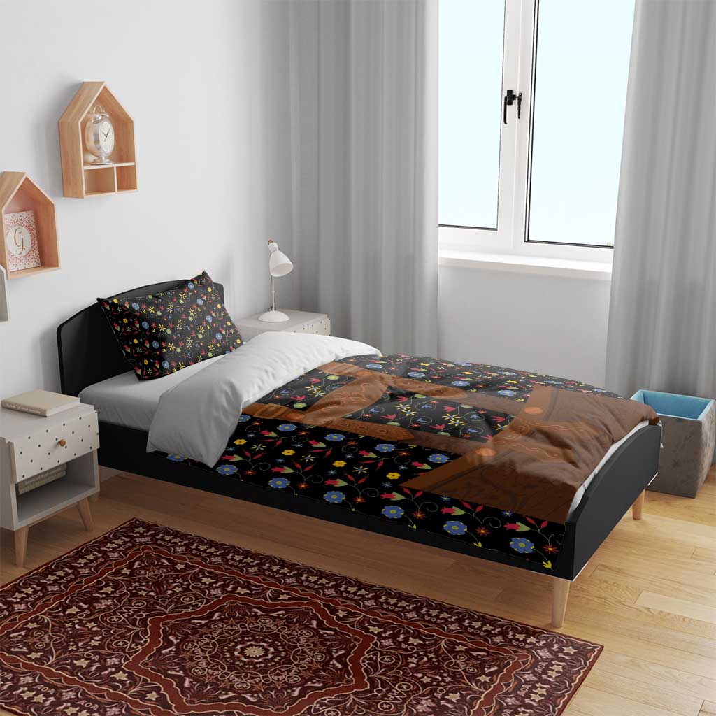 Black duvet set with colorful flower print and brown lederhosen-style graphic on the bed