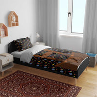 Black duvet set with colorful flower print and brown lederhosen-style graphic on the bed