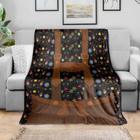 Black folk floral blanket with brown lederhosen-style chest straps and apron panel