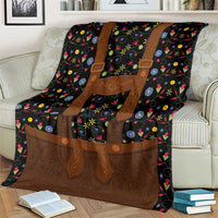 Black folk floral blanket with brown lederhosen-style apron and colorful flower motifs