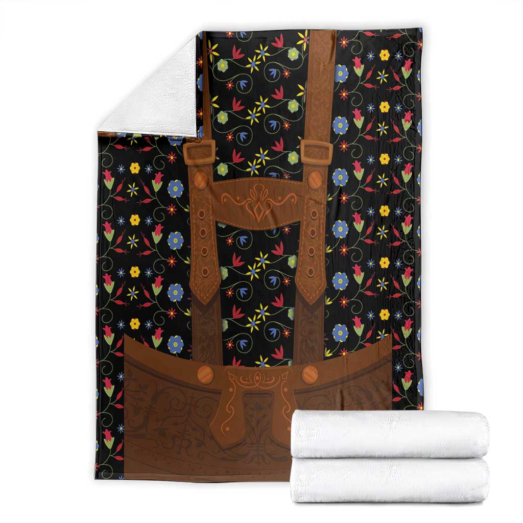 Black folk floral blanket with brown lederhosen chest panel, straps, and flower pattern