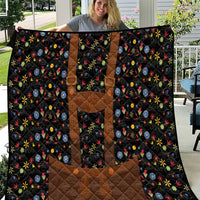 Black quilted bed blanket with brown panels and multicolor floral folk pattern