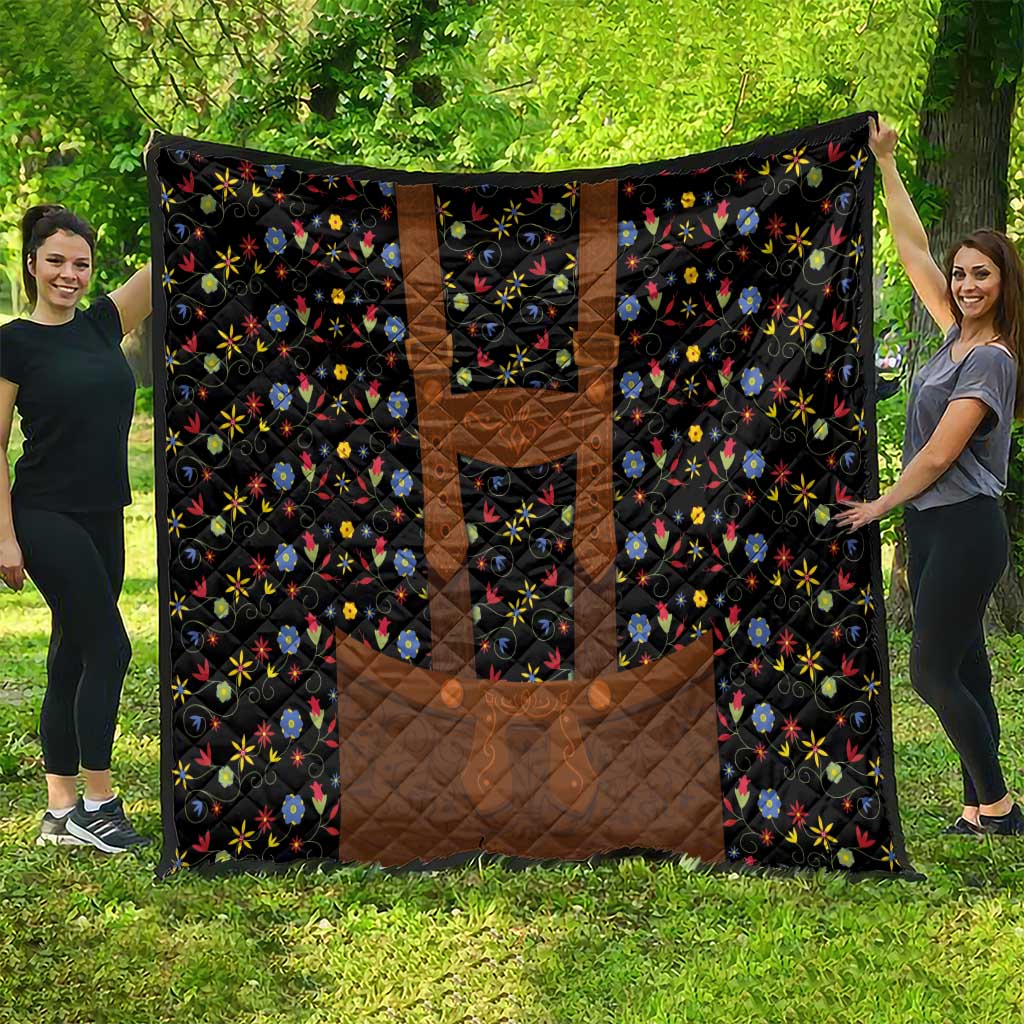 Black quilt blanket with brown center panels and colorful floral folk design
