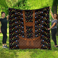 Black quilt blanket with brown center panels and colorful floral folk design