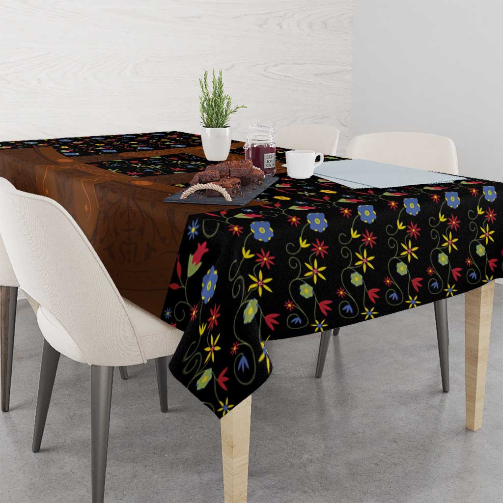 Black folk floral tablecloth draped on table with brown lederhosen-style center panel
