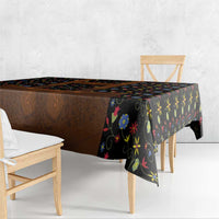 Black folk floral tablecloth on bench table with brown lederhosen-style centerpiece
