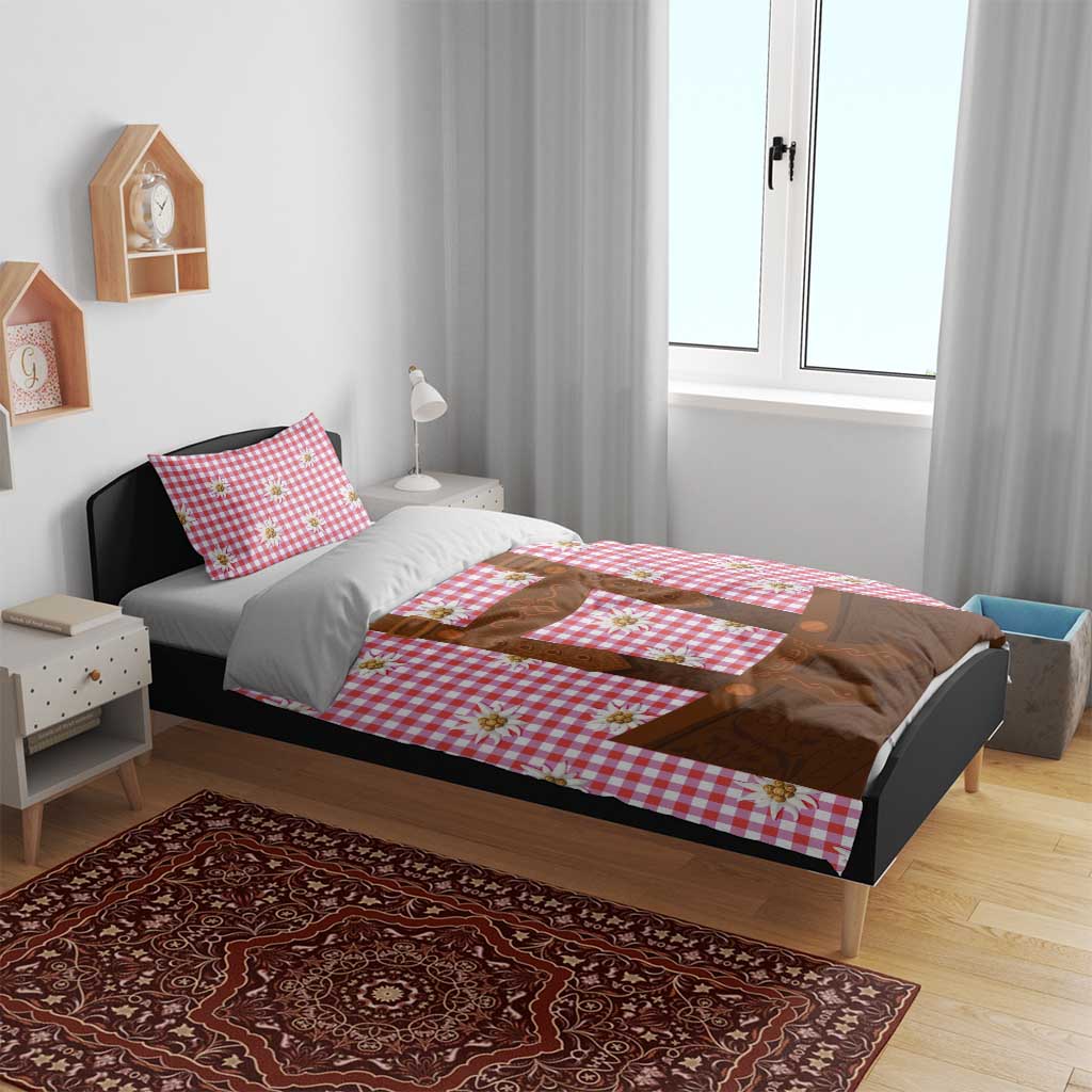 Red plaid duvet cover with brown lederhosen applique and edelweiss flowers on bed