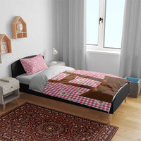 Red plaid duvet cover with brown lederhosen applique and edelweiss flowers on bed