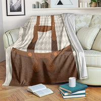 Beige and brown lederhosen-themed blanket with diamond pattern and apron graphic