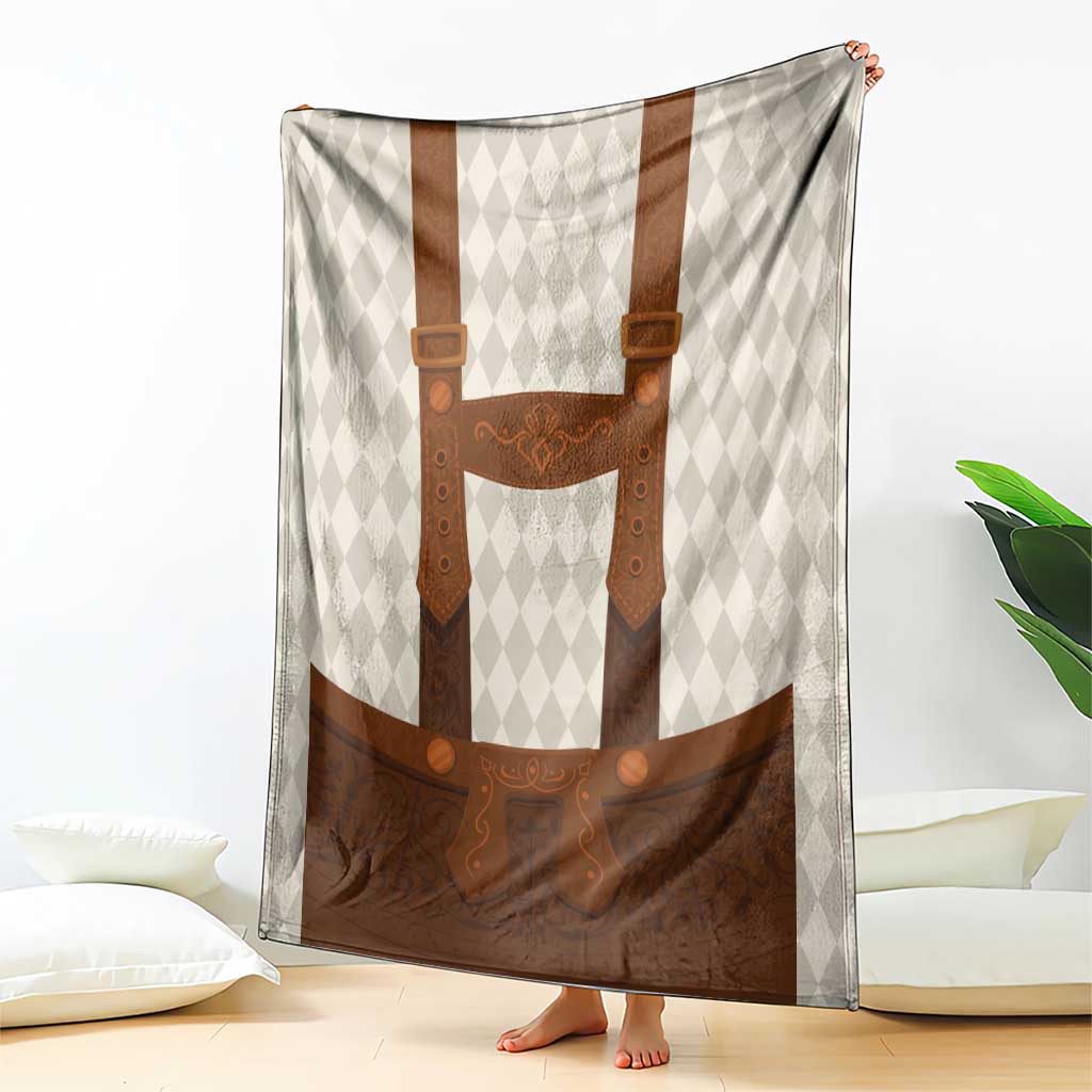 Beige diamond-pattern blanket with brown lederhosen bib, suspenders, and apron print