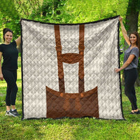 Large white quilt blanket with brown lederhosen motif, quilted diamond texture
