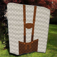 White diamond quilt blanket with brown lederhosen applique, centered vertical panel