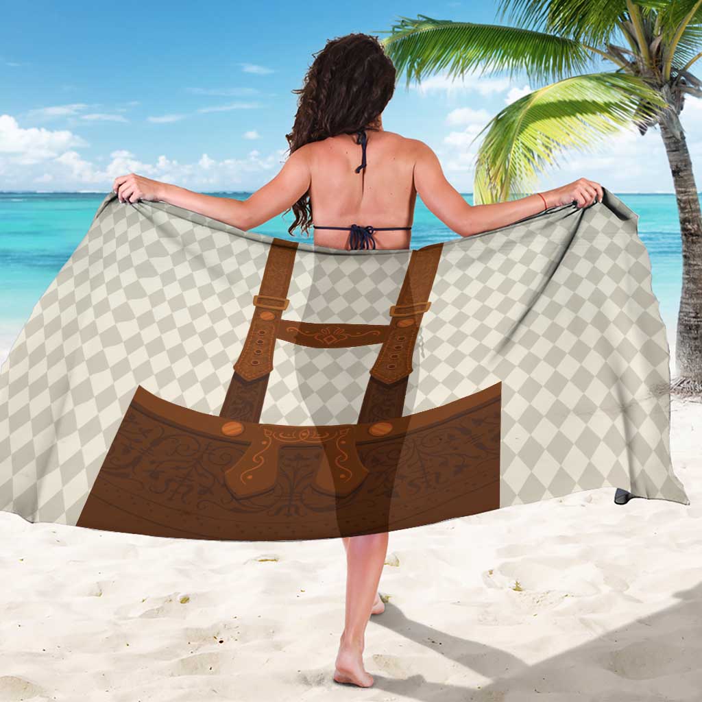 Beige diamond-pattern sarong with brown leather-style apron straps, worn as wrap