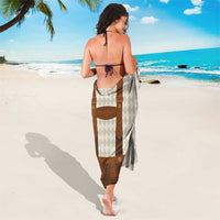 Beige diamond-pattern sarong with brown front bib and adjustable leather-style straps