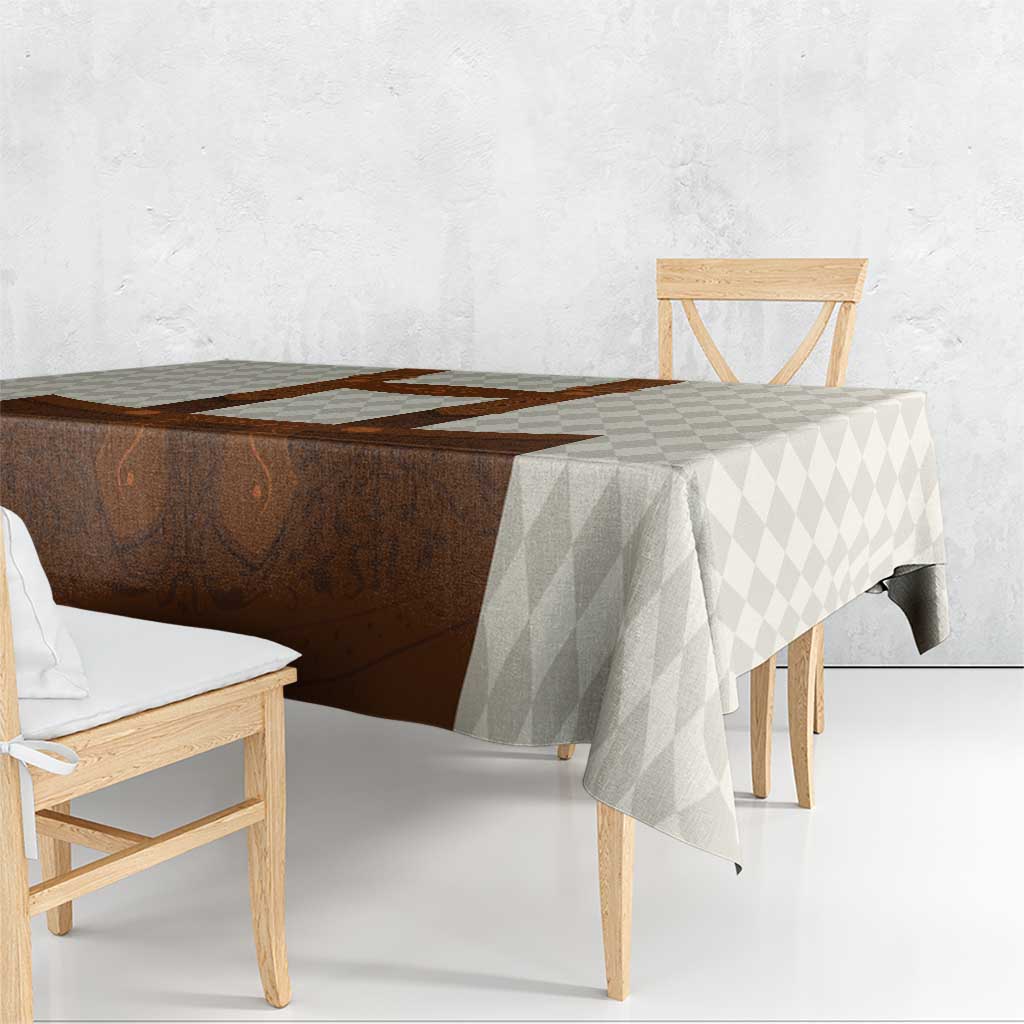 Beige diamond tablecloth with brown lederhosen design, flowing over table edge