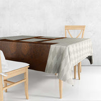 Beige diamond tablecloth with brown lederhosen design, flowing over table edge