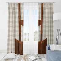 Beige diamond-pattern window curtain panels with brown lederhosen-style motif and rings