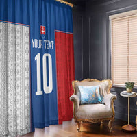 Hanging window curtains in blue and red with large printed number and crest