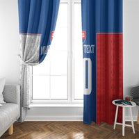 Window curtain panels beside a white door frame; blue and red with printed number