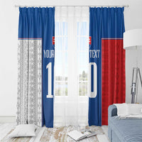 Front view of window curtains in blue, red, and gray patterns with large number print