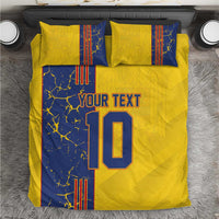 Top view of yellow and blue bedding set with pillows; 'YOUR TEXT' and number 10