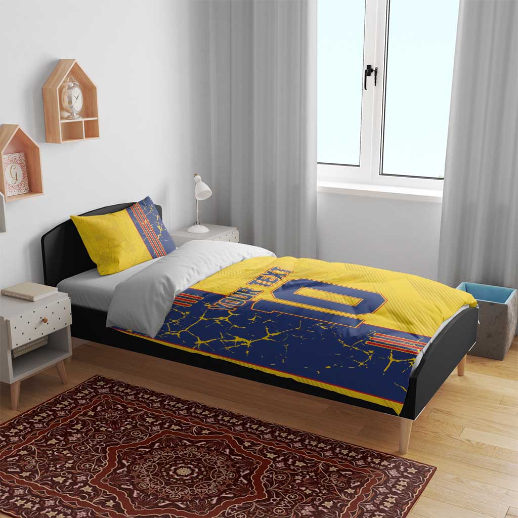 Yellow and blue duvet cover bedding set on bed, 'YOUR TEXT' and number 10