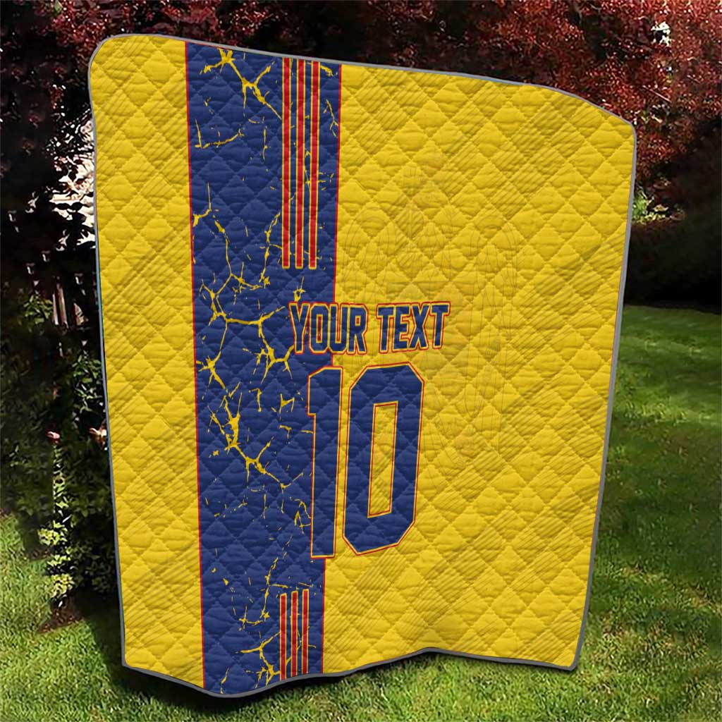 Yellow quilt blanket with blue panel, custom text and number 10, neatly draped